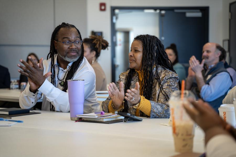 Participants applauding at a table